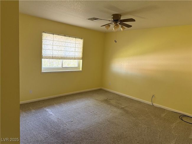 Carpeted spare room featuring a ceiling fan and baseboards | Image 18