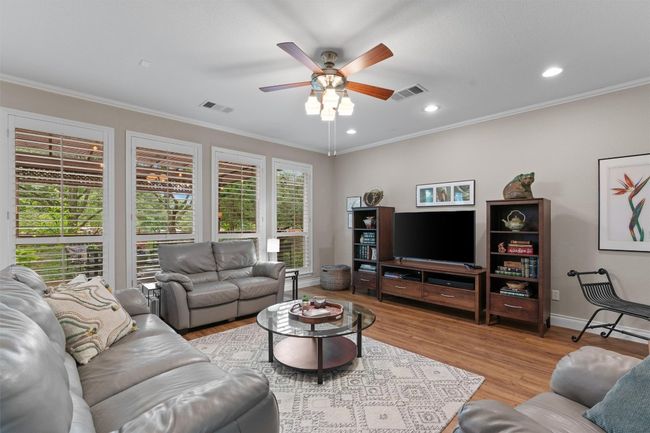 Living room featuring ceiling fan, wood finished floors, crown molding, recessed lighting, and baseboards | Image 6