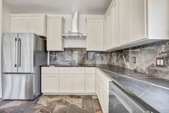 Stone floors, custom cabinets, counters and stainless appliances | Image 28
