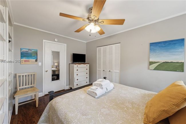 Second bedroom with stylish built in shelving, ample natural lighting if desired, hardwood floors. | Image 51