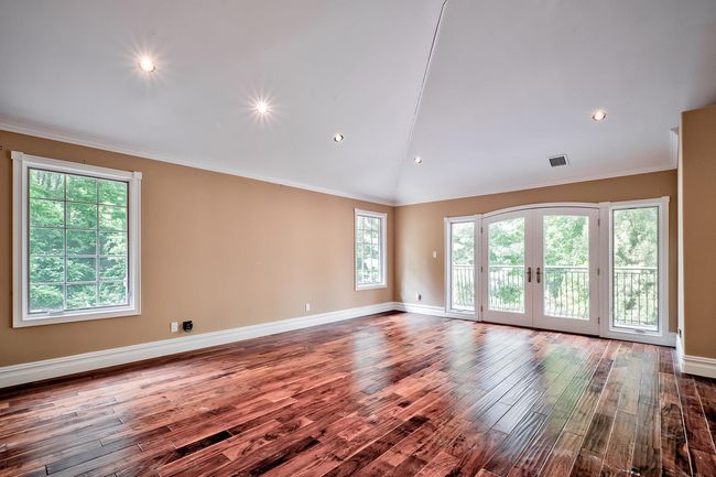 Spare room featuring ornamental molding, french doors, wood finished floors, and visible vents | Image 16