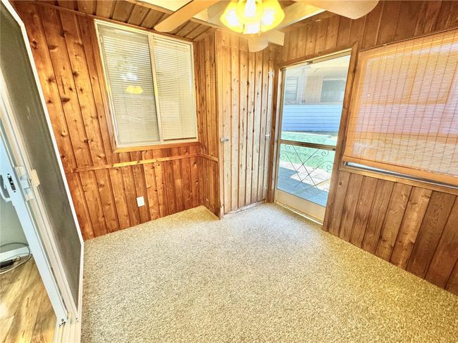 Screened porch with storage closet. Door to outside and glass door to living room | Image 22