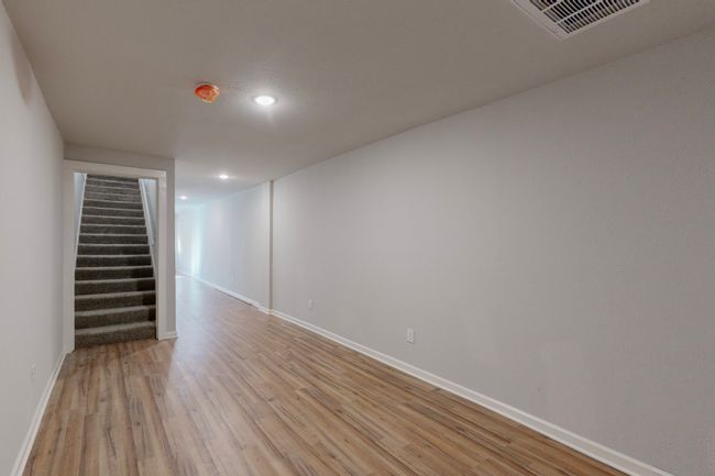 Basement featuring light wood-type flooring | Image 10