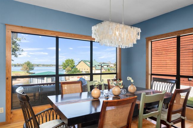 Dining space with a chandelier, hardwood / wood-style floors, and a water view | Image 16