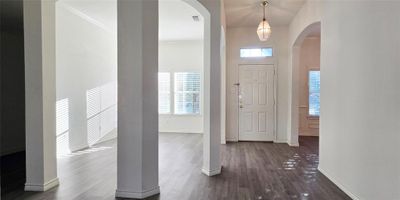 Foyer with dark wood-type flooring and crown molding | Image 2