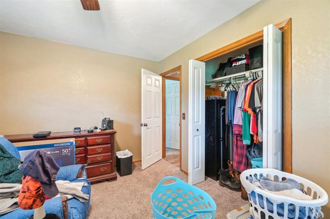 Bedroom featuring light colored carpet, a closet, and a ceiling fan | Image 20