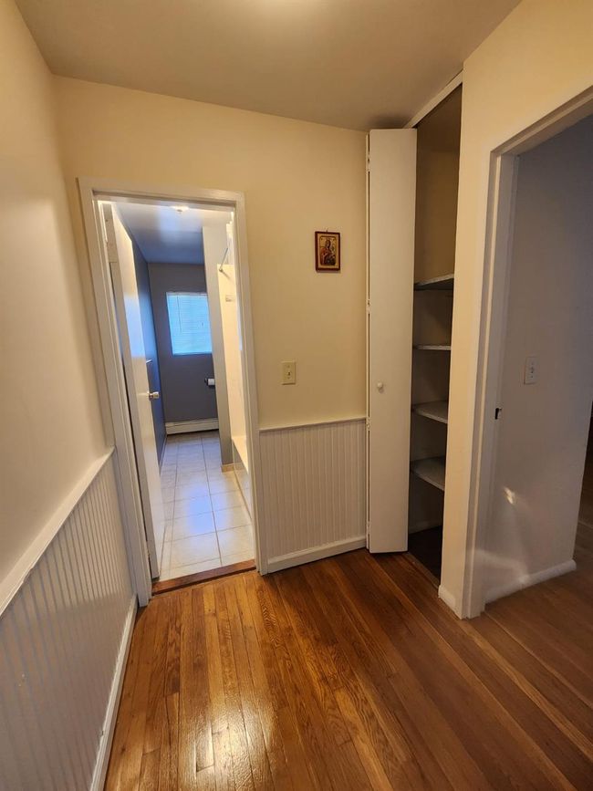 Hallway featuring hardwood / wood-style floors and a wainscoted wall | Image 9