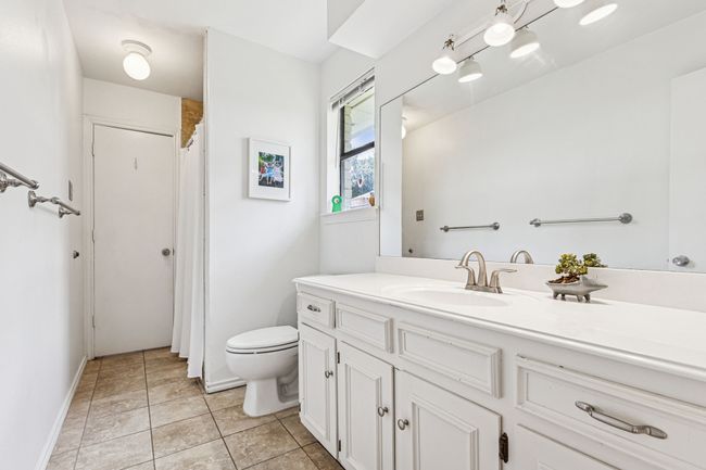 Full bathroom featuring toilet, vanity, and tile patterned floors | Image 18