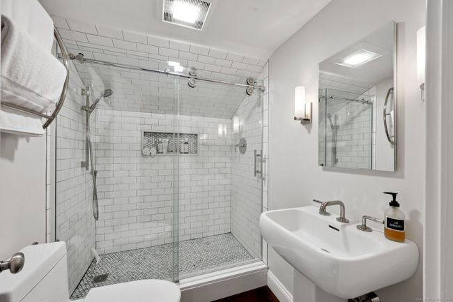 Upper level beautifully remodeled full bathroom. | Image 21