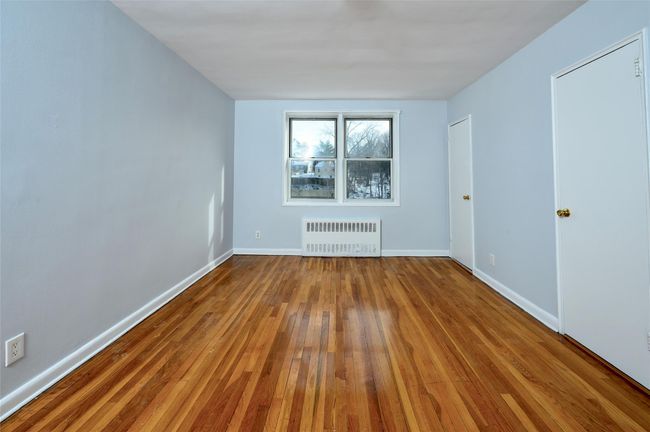 Unfurnished room with radiator and hardwood / wood-style floors | Image 11