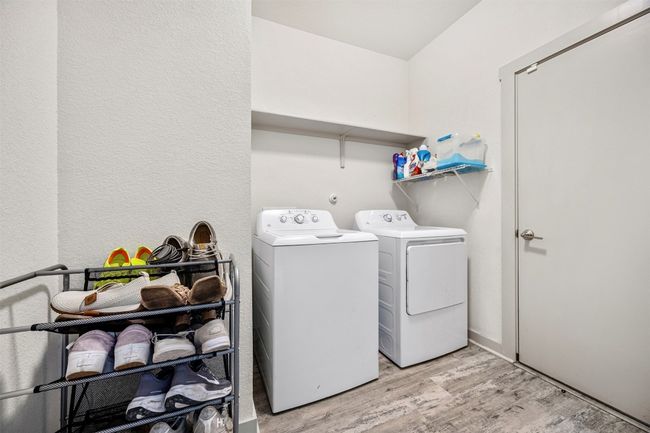 Conveniently located laundry room with washer and dryer hookups, providing extra storage space on the shelf above. | Image 19