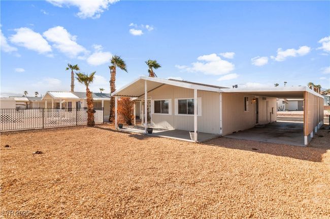Back of property with fence and an attached carport | Image 37