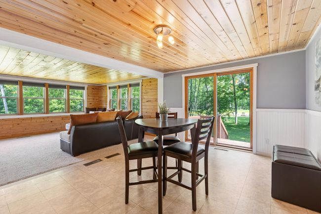 Dining area with double sliding doors to large deck | Image 6