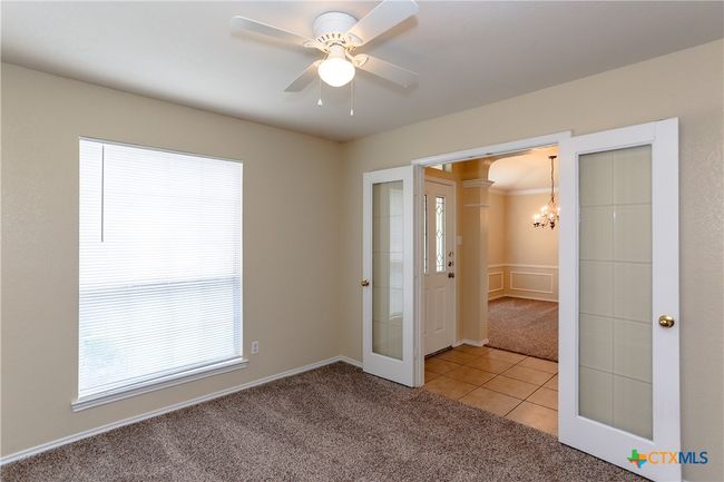 Big window in the first bedroom, ceiling fan. | Image 11