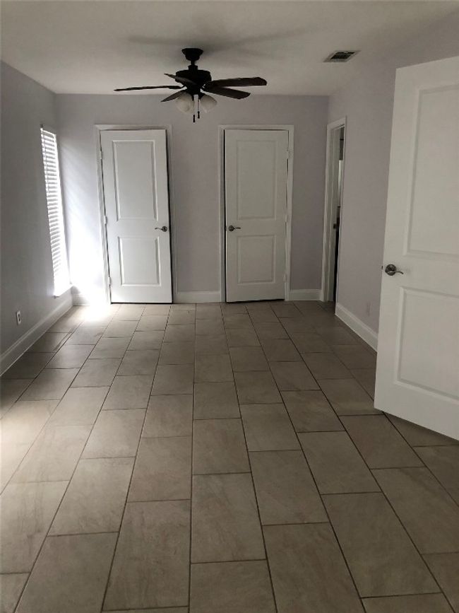 Unfurnished room with ceiling fan and light tile patterned flooring | Image 13