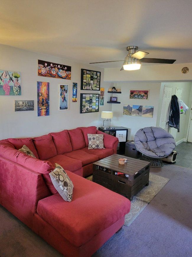 Living room with carpet and ceiling fan | Image 7