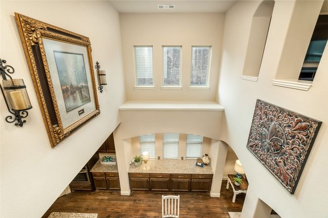 Foyer entrance with arched walkways and dark wood finished floors | Image 21