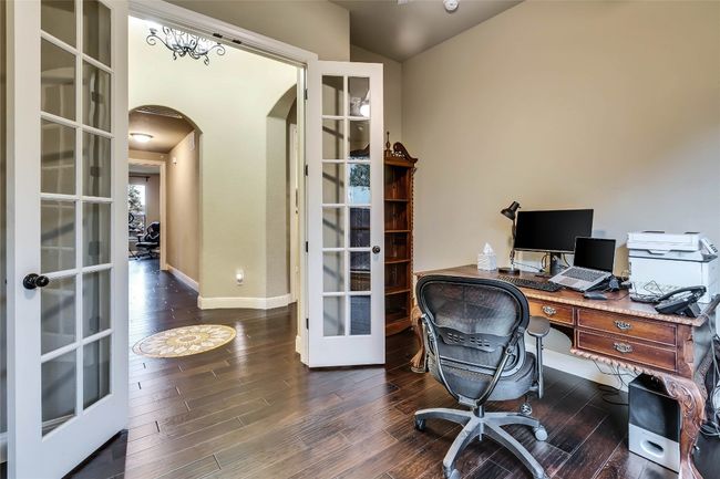 Office area featuring french doors, arched walkways, wood finished floors, and lofted ceiling | Image 15