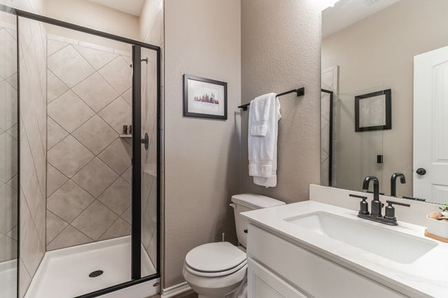 Full bathroom featuring vanity, a shower stall, and a textured wall | Image 15