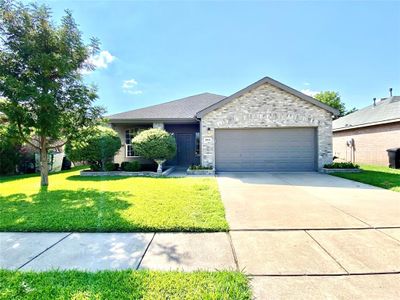 View of front of house with a garage and a front lawn | Image 1