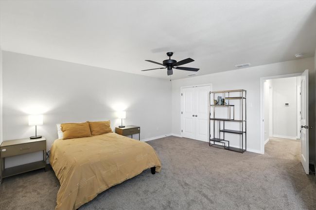 Carpeted bedroom with a closet and ceiling fan | Image 33
