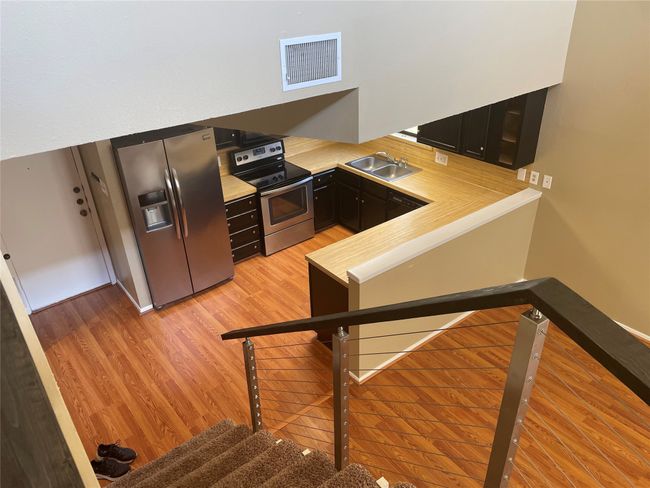 Kitchen featuring light hardwood / wood-style floors, sink, and appliances with stainless steel finishes | Image 6