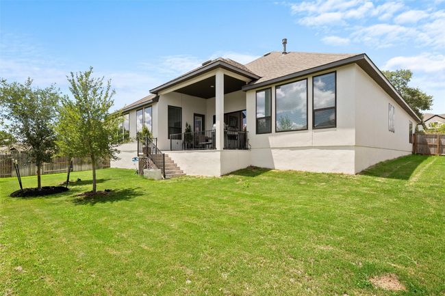 Back of house with stucco siding, a fenced backyard, stairway, and roof with shingles | Image 37
