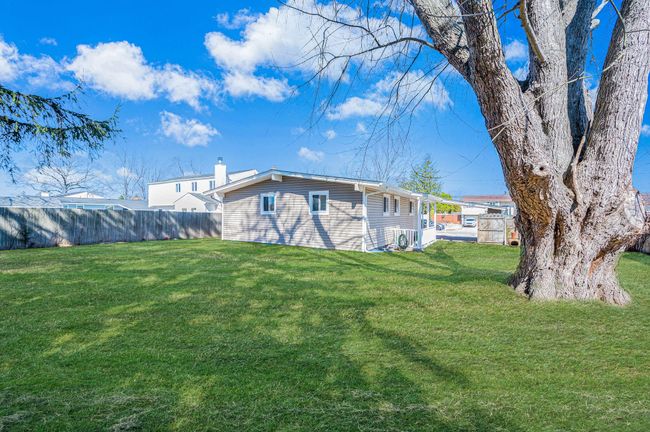 View of yard with a fenced backyard and a patio area | Image 25