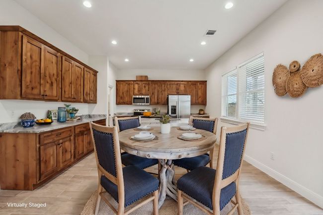 Virtually Staged Dining room with visible vents, recessed lighting, baseboards, and wood plank tile floor | Image 11