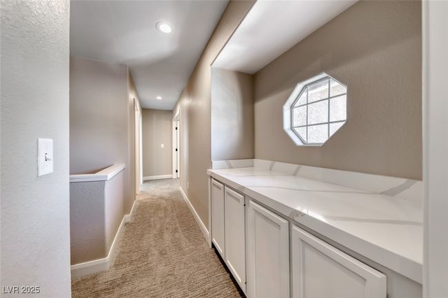 Hallway with light carpet and recessed lighting | Image 17