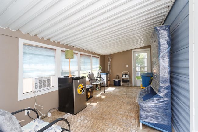 Sunroom / solarium featuring lofted ceiling and cooling unit | Image 7