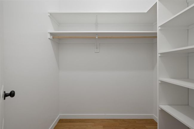 Spacious closet featuring light wood-style flooring | Image 28