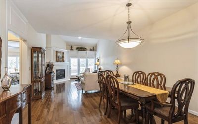 Dining area with lofted ceiling and dark hardwood / wood-style floors | Image 2