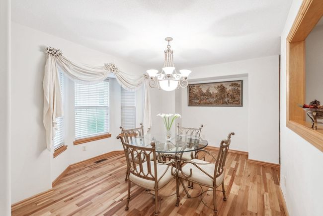 Dining area featuring a chandelier, light wood finished floors, and baseboards | Image 9