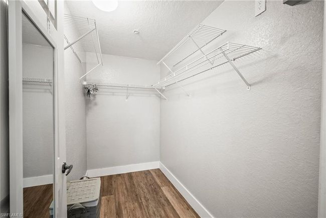 Spacious closet featuring wood finished floors | Image 19