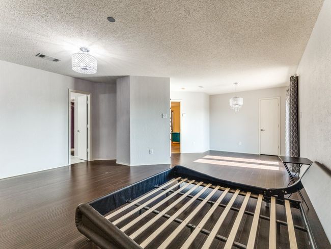 Empty room featuring a textured ceiling and wood finished floors | Image 17