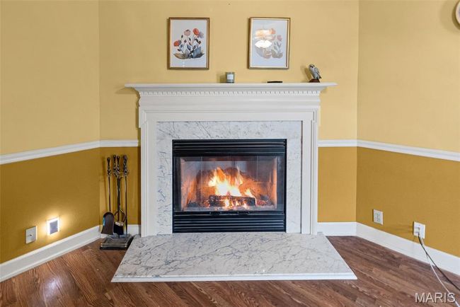 Detailed view of wood finished floors and a fireplace | Image 14