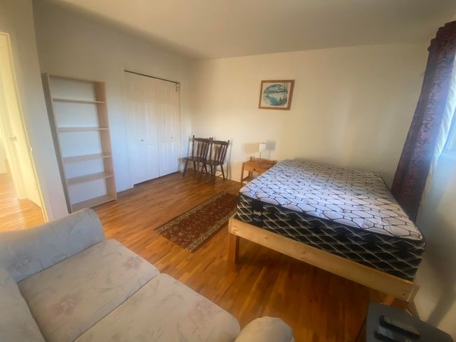 Bedroom with a closet and wood finished floors | Image 6