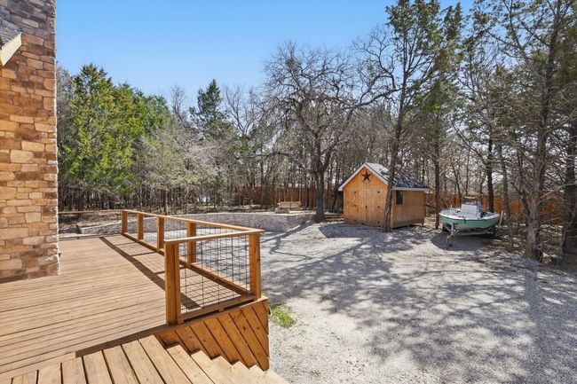 View of yard featuring a storage shed, a deck, and an outbuilding | Image 13