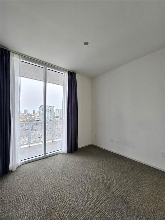 Unfurnished room featuring baseboards, floor to ceiling windows, and carpet | Image 7
