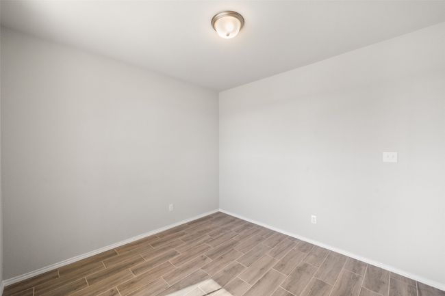 Spare room with wood tiled floor and baseboards | Image 33