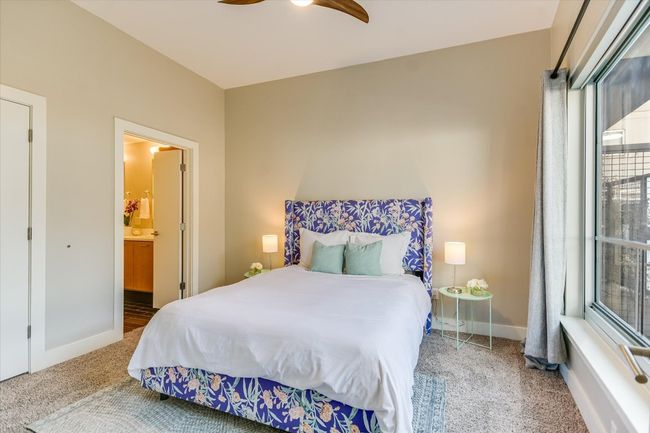 Bedroom with ceiling fan, baseboards, carpet floors, and connected bathroom | Image 9
