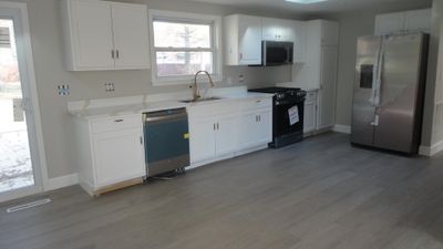 New appliances, cabinetry, flooring and lighting. | Image 2