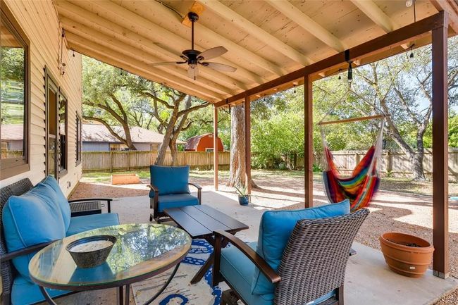 Fenced backyard with a patio and ceiling fan | Image 24