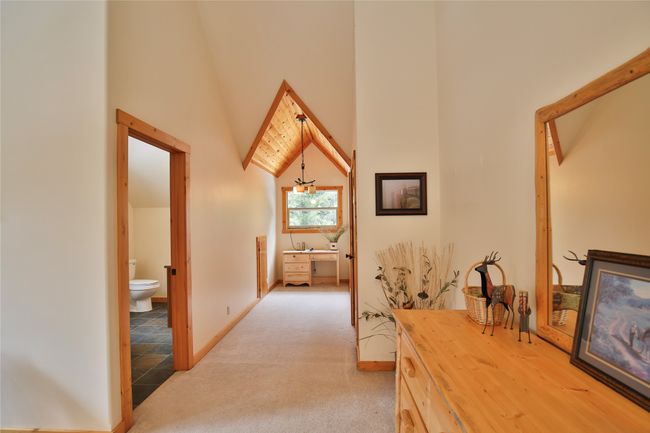 Corridor with baseboards, light colored carpet, and a towering ceiling | Image 43