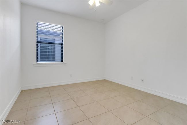Unfurnished room featuring ceiling fan, baseboards, and light tile patterned floors | Image 13