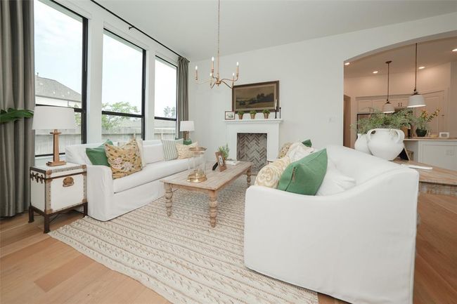 Effortlessly control natural light with sleek electric shades in the living room. | Image 14