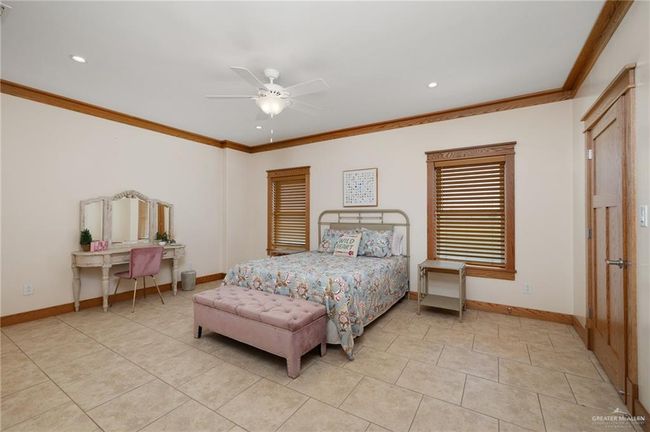 Tiled bedroom featuring ceiling fan and ornamental molding | Image 14