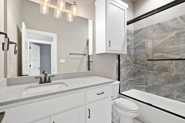 Full bathroom with vanity and shower / bath combination with glass door | Image 27