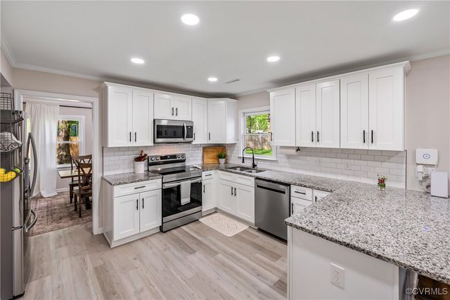 Kitchen with appliances with stainless steel finishes, granite, backsplash, soft close cabinets | Image 7